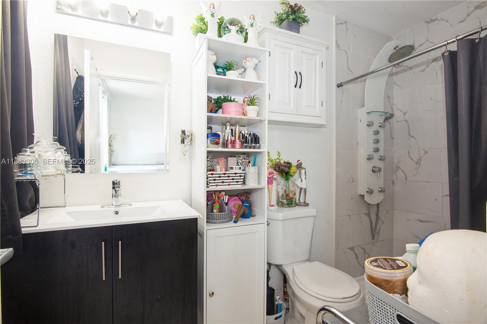 14366 Southwest 258th Lane Homestead, FL 33032 - Photo 19 of 24 a bathroom with a sink toilet vanity and shower