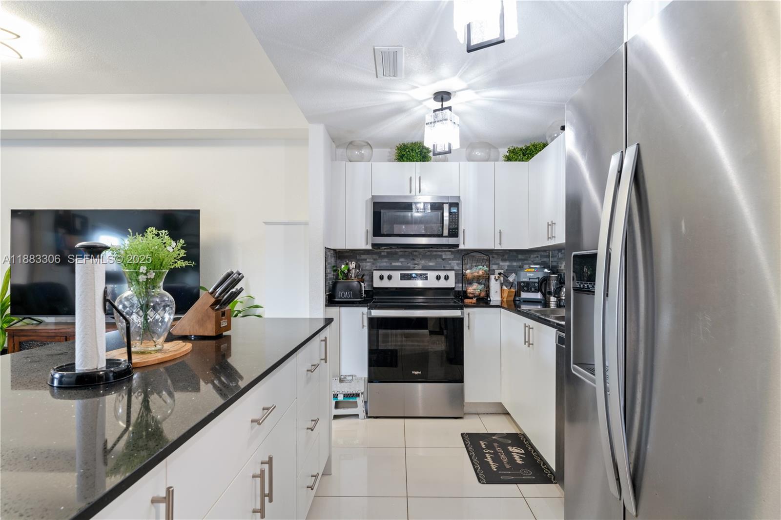 14366 Southwest 258th Lane Homestead, FL 33032 - Photo 4 of 24 a kitchen with stainless steel appliances a stove a refrigerator and a sink