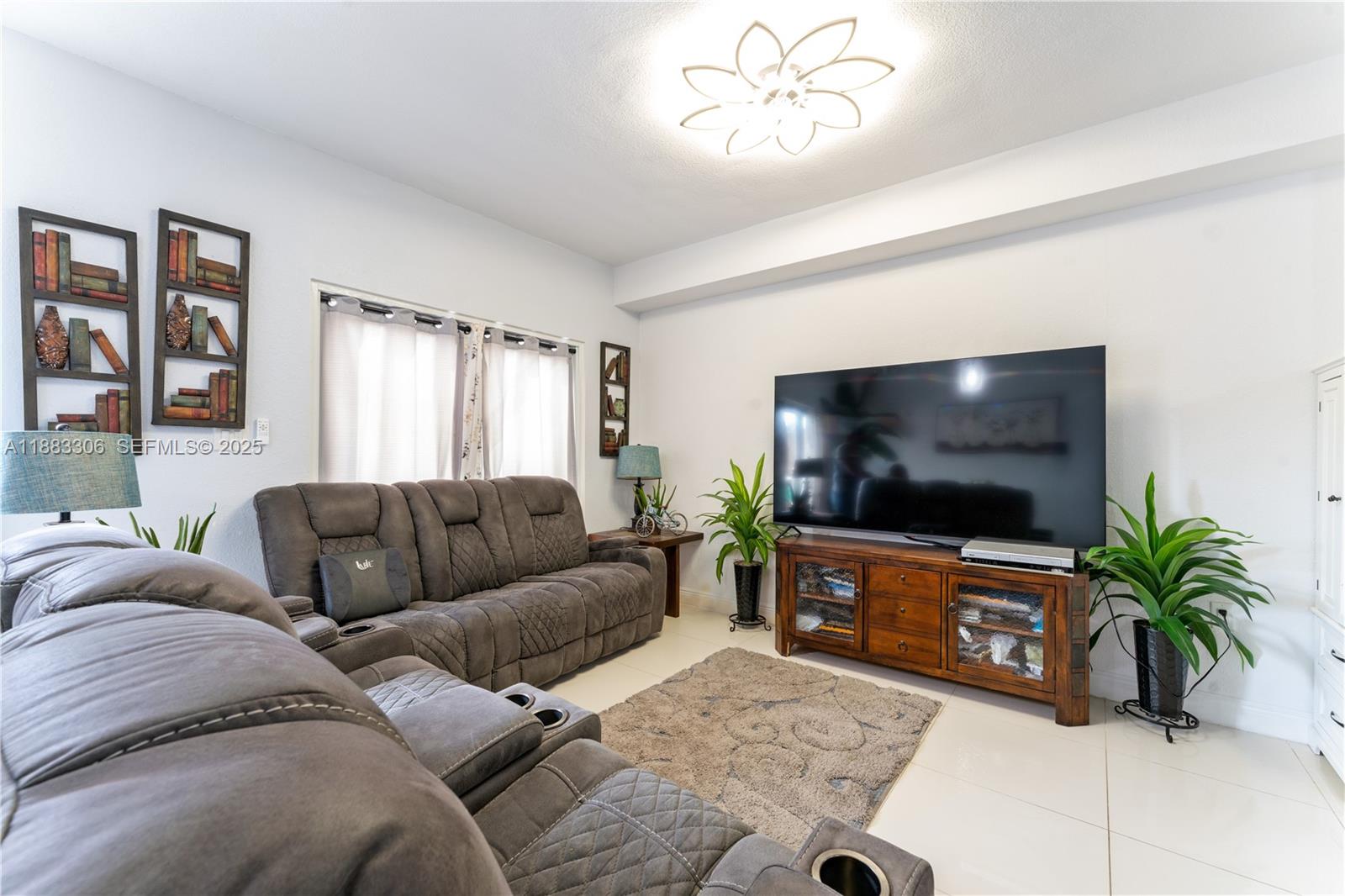 14366 Southwest 258th Lane Homestead, FL 33032 - Photo 7 of 24 a living room with furniture and a flat screen tv