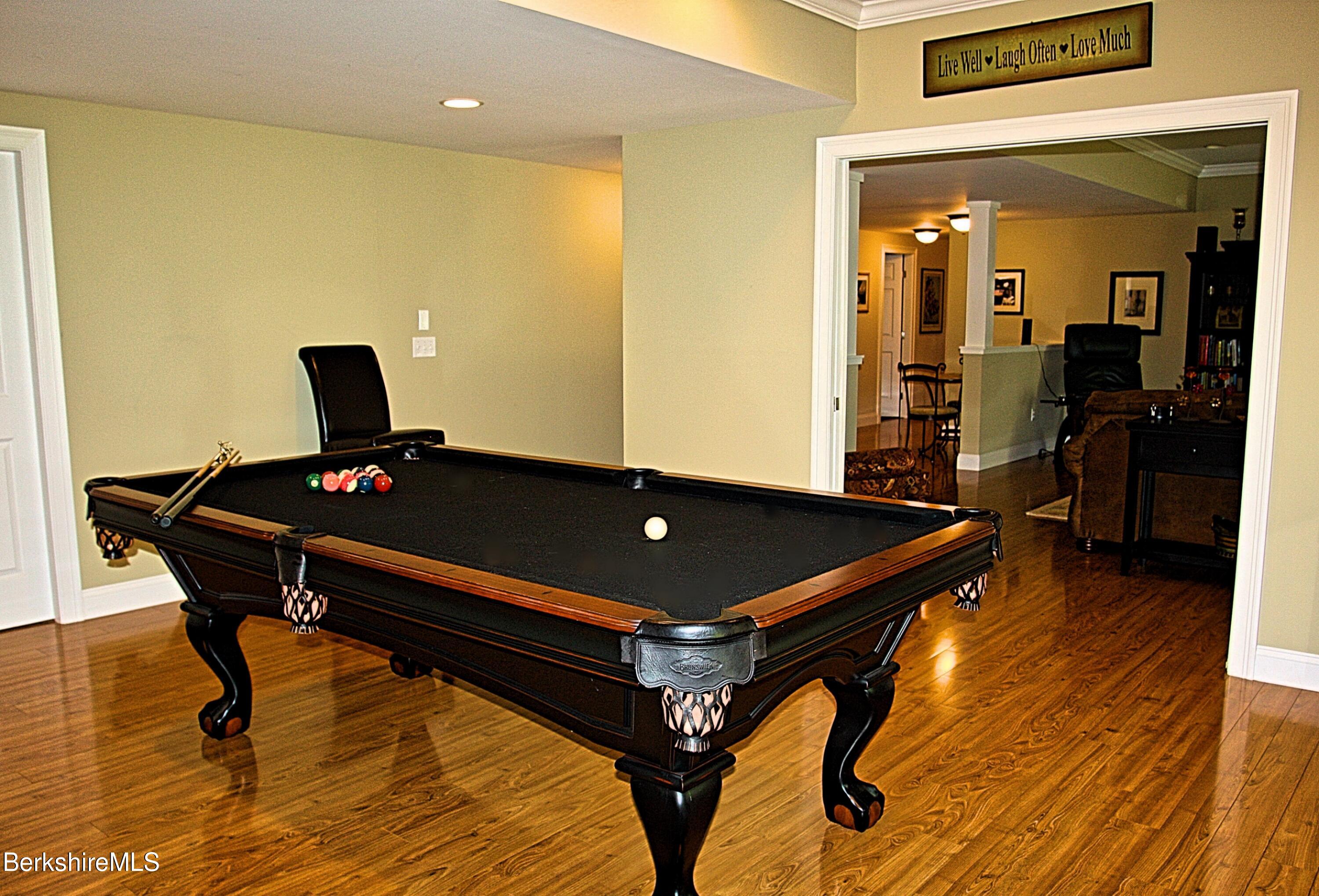 249 Woodmere Road Becket, MA 01223 - Photo 18 of 23 a room with wooden floor pool table and windows