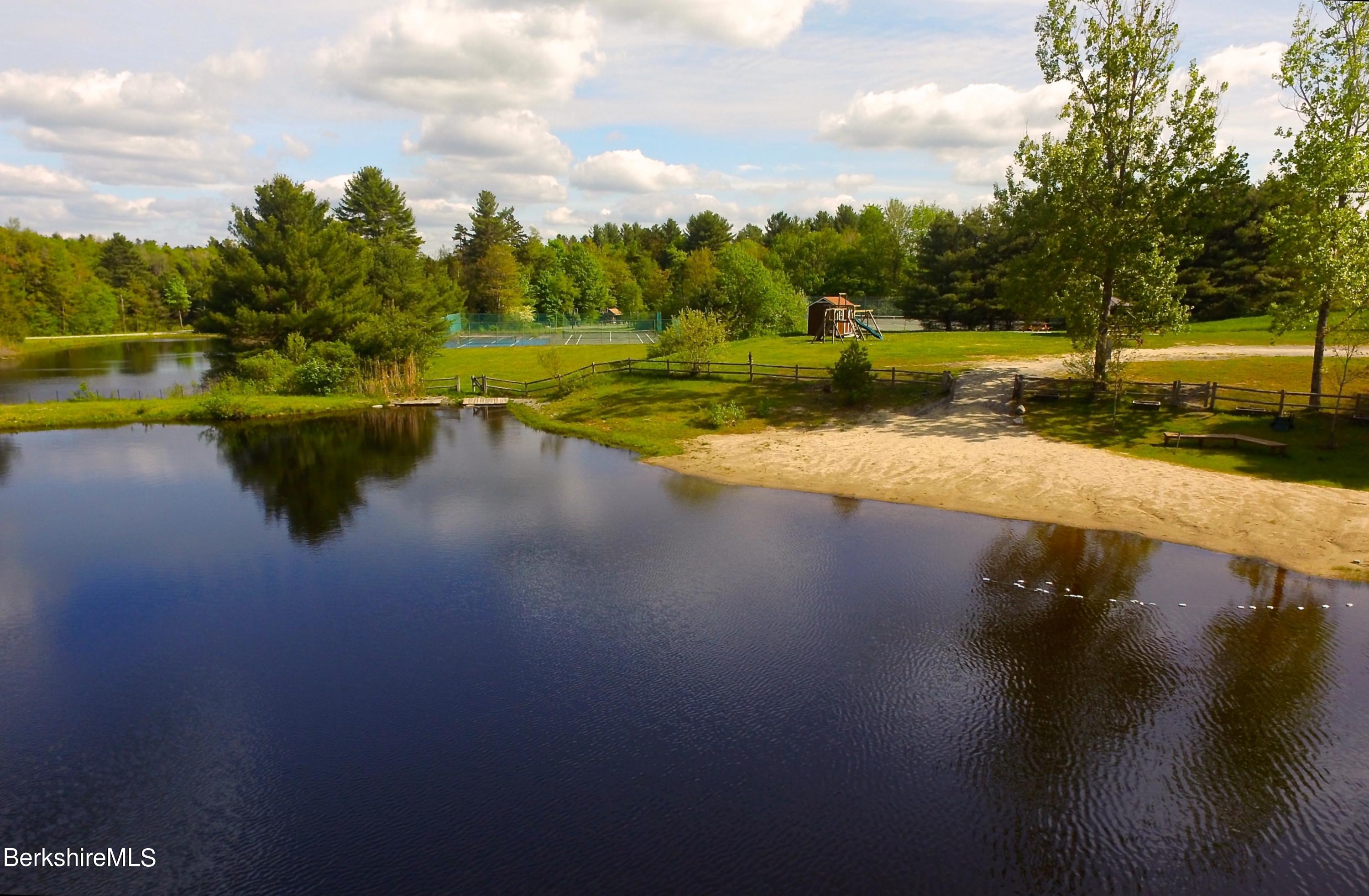 249 Woodmere Road Becket, MA 01223 - Photo 21 of 23 a view of a lake with houses in the background
