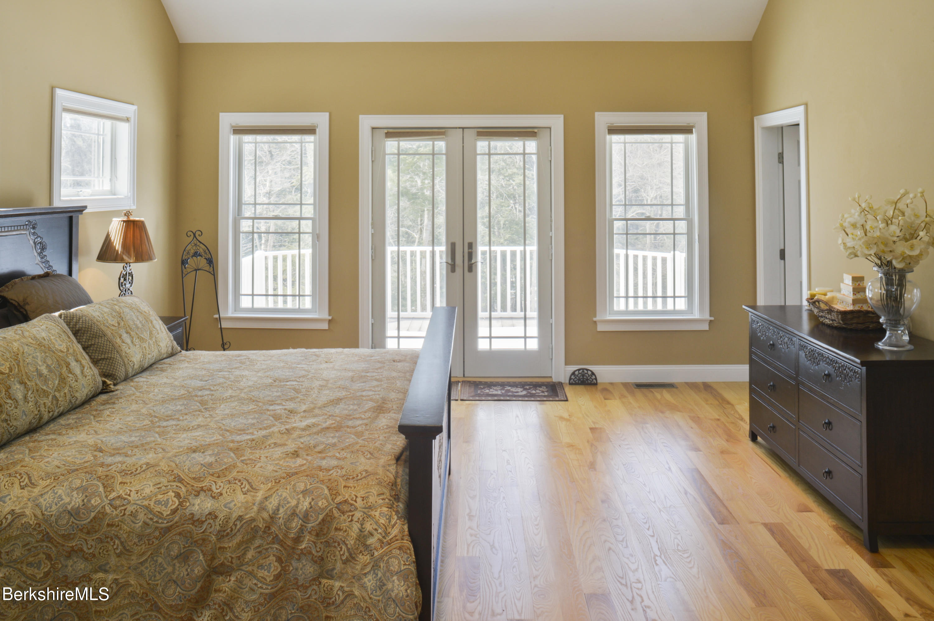 249 Woodmere Road Becket, MA 01223 - Photo 9 of 23 a spacious bedroom with a bed and wooden floor