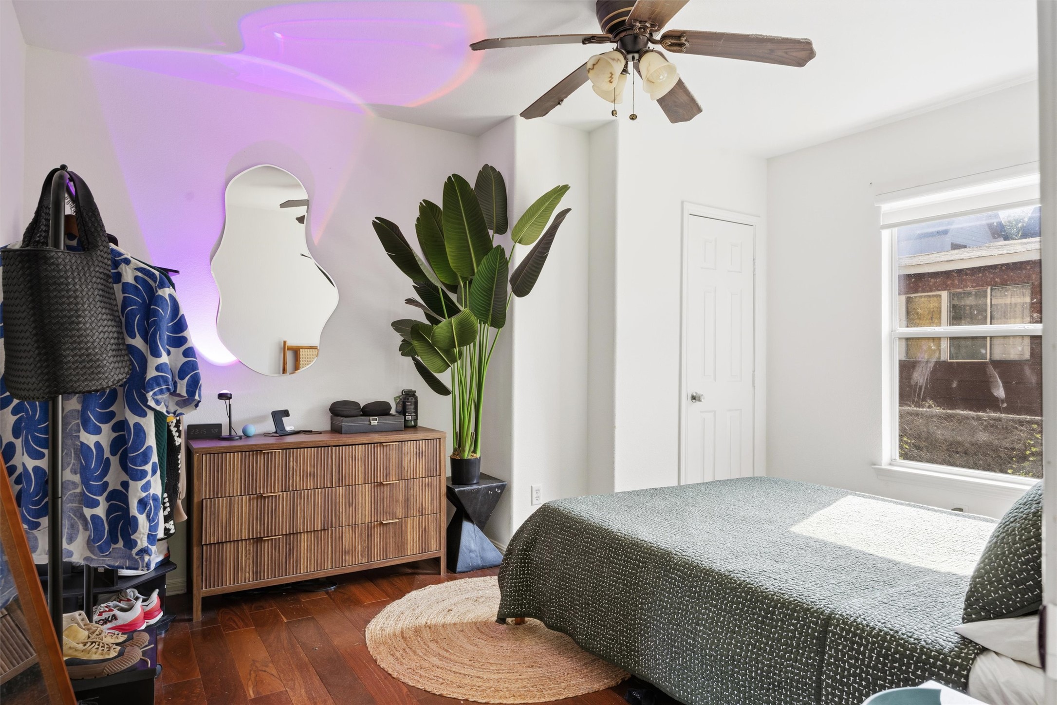 3015 Castro Street Austin, TX 78702 - Photo 19 of 40 Hardwood floors and a ceiling fan create comfort in this naturally illuminated bedroom.