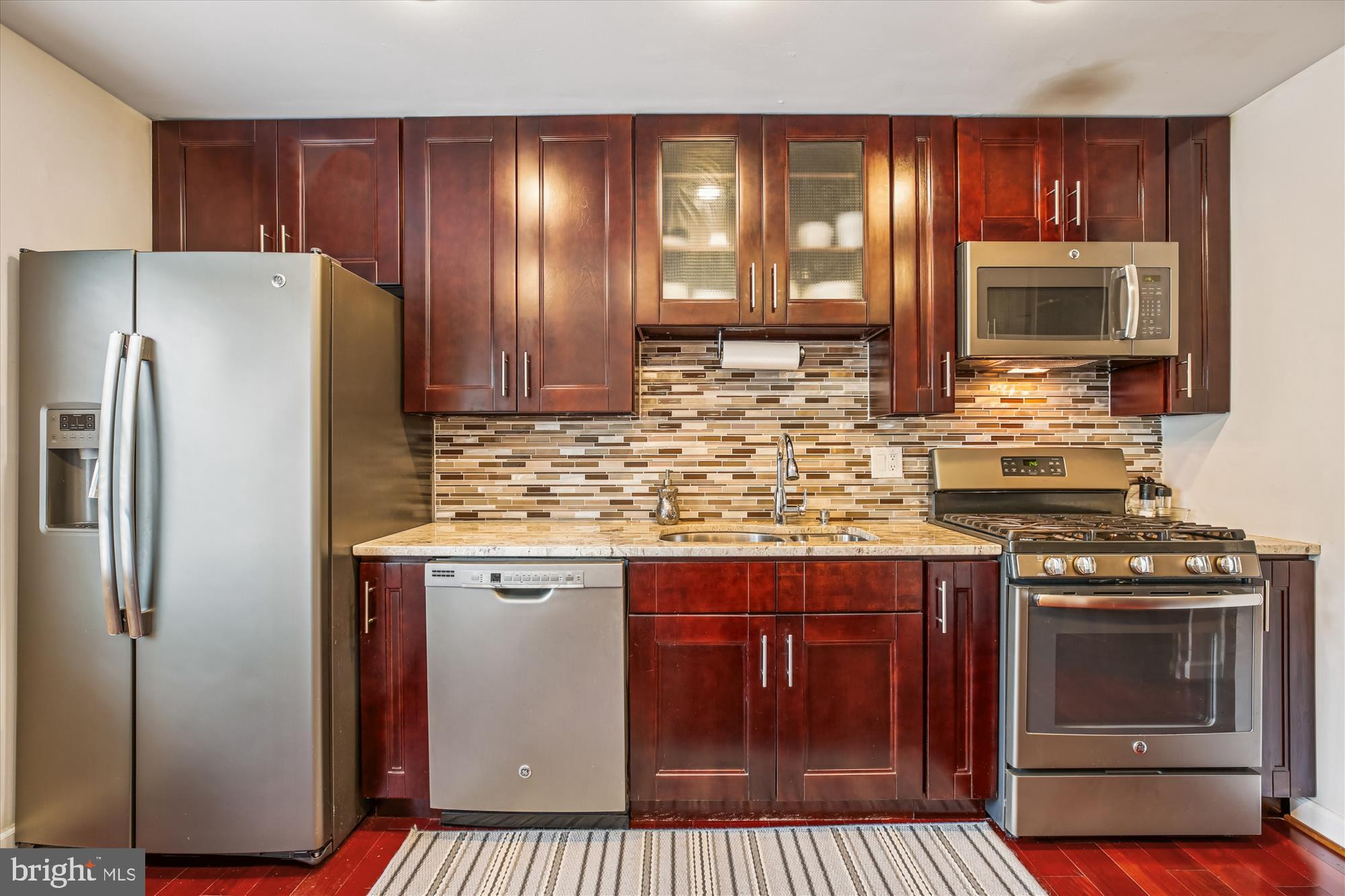 2702 Atlanta Drive, Unit 72702 Silver Spring, MD 20906 - Photo 14 of 55 a kitchen with granite countertop a stove top oven and refrigerator