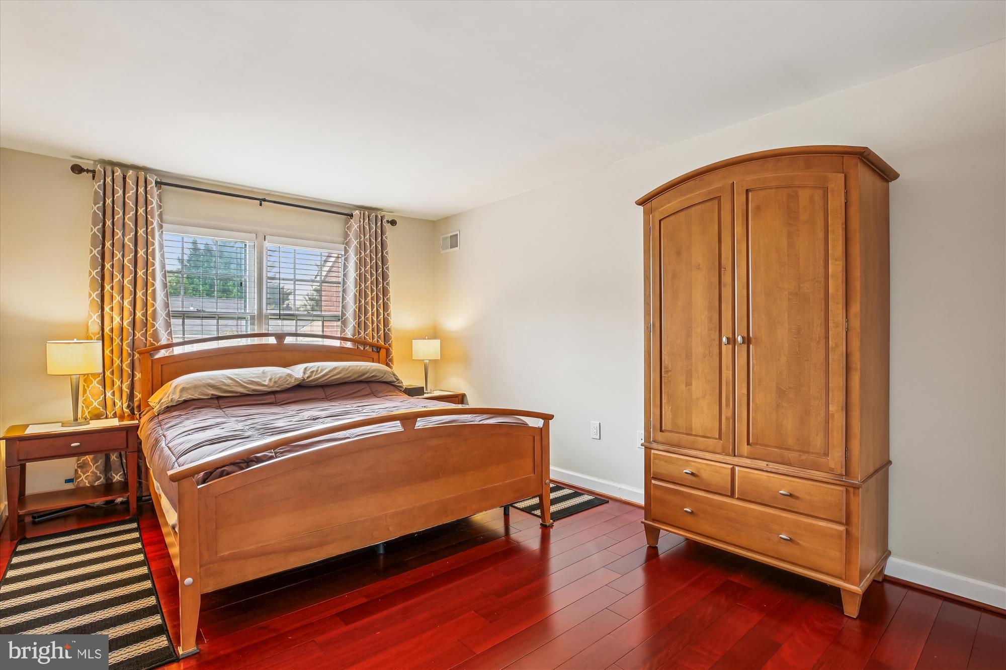 2702 Atlanta Drive, Unit 72702 Silver Spring, MD 20906 - Photo 21 of 55 a bedroom with a bed and wooden floor