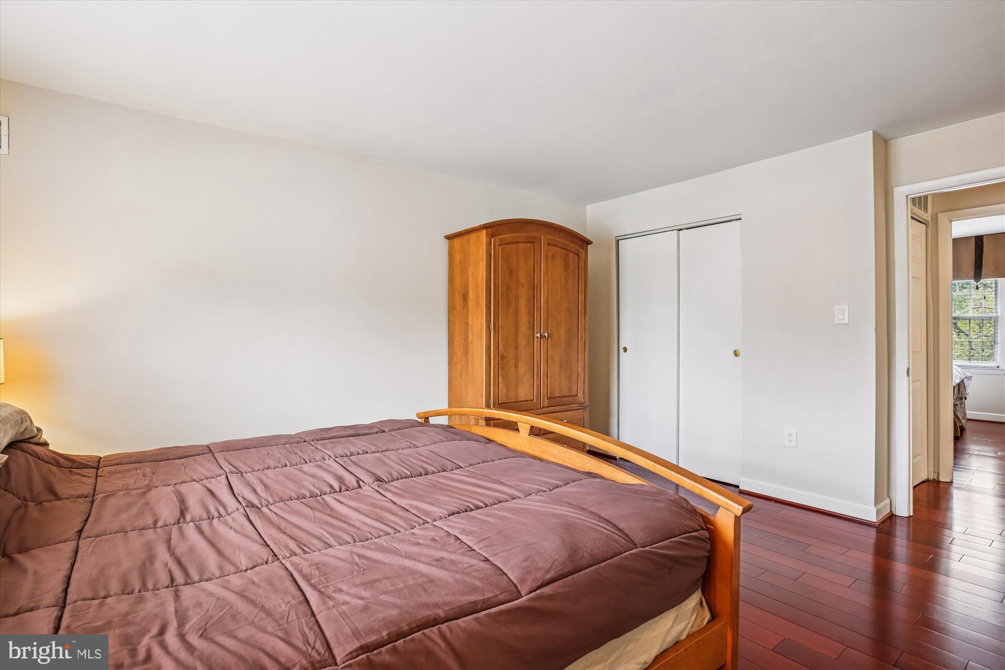 2702 Atlanta Drive, Unit 72702 Silver Spring, MD 20906 - Photo 22 of 55 a bedroom with a bed and wooden floor