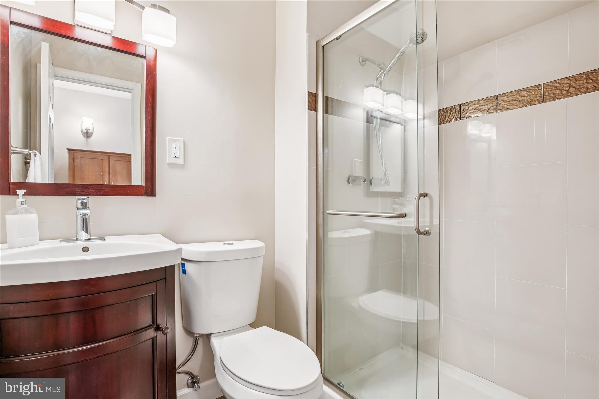 2702 Atlanta Drive, Unit 72702 Silver Spring, MD 20906 - Photo 24 of 55 a bathroom with a toilet a sink and a mirror