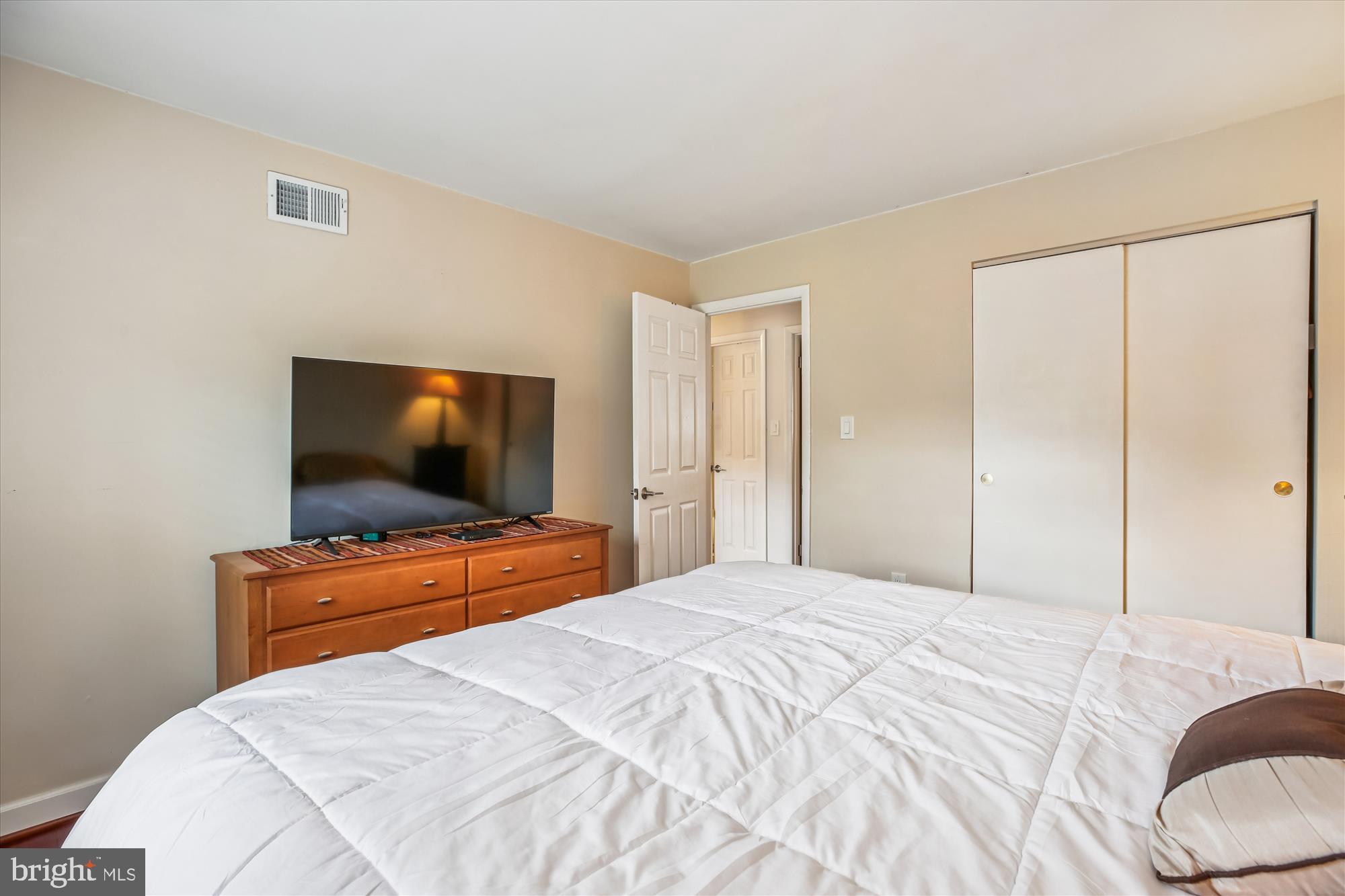 2702 Atlanta Drive, Unit 72702 Silver Spring, MD 20906 - Photo 29 of 55 a bedroom with a bed and a flat screen tv