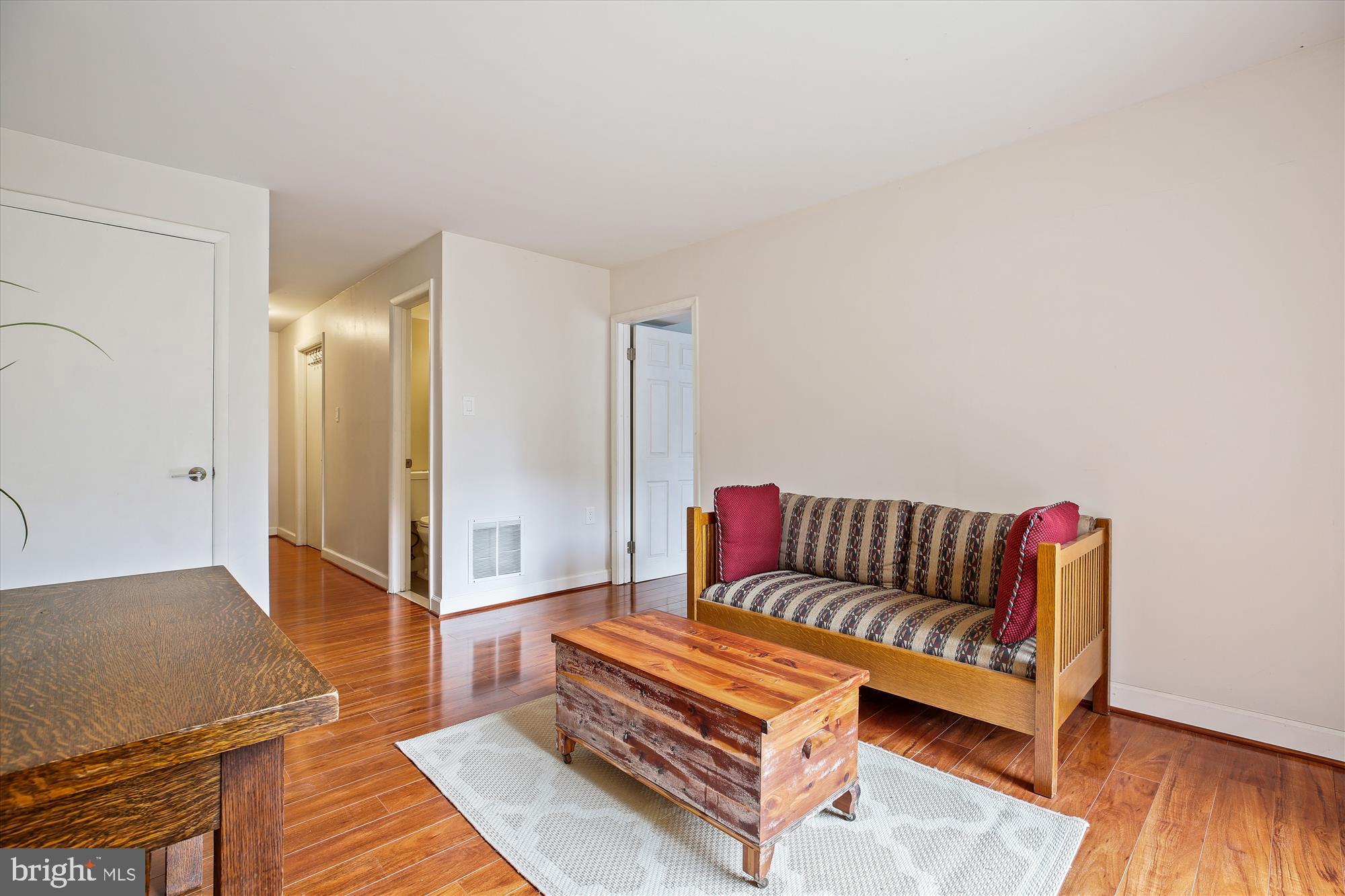 2702 Atlanta Drive, Unit 72702 Silver Spring, MD 20906 - Photo 40 of 55 a living room with furniture and a wooden floor