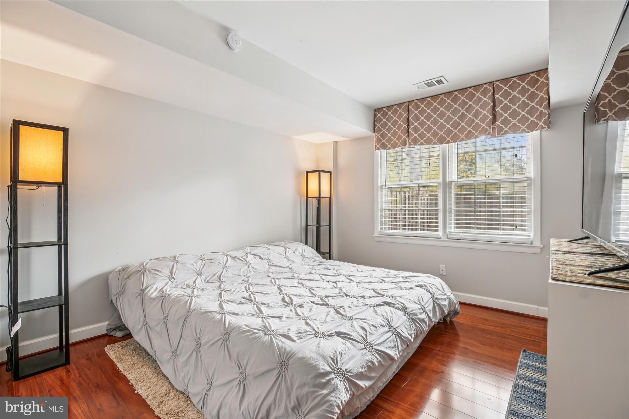 2702 Atlanta Drive, Unit 72702 Silver Spring, MD 20906 - Photo 41 of 55 a bed sitting in a bedroom next to a window