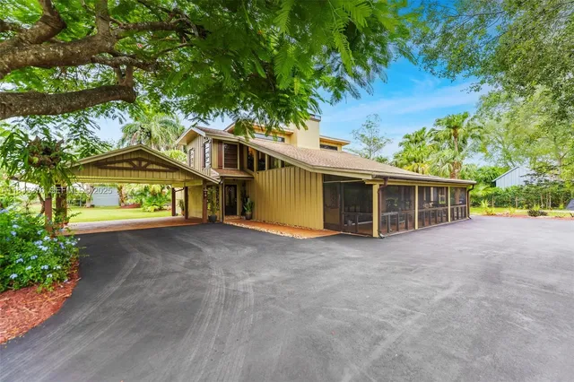 a view of a house with a garage and balcony