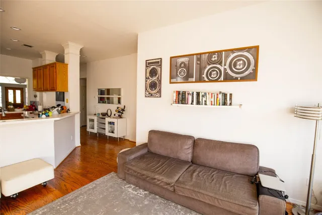 a living room with furniture and kitchen view