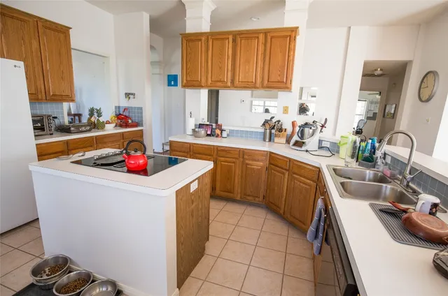 a kitchen with a sink a stove and cabinets