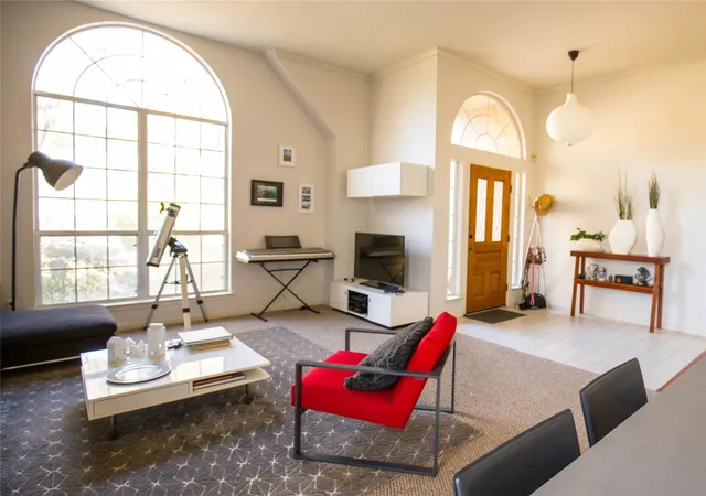 a living room with furniture a fireplace and a table