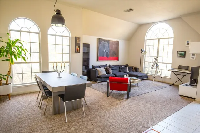 a dining room with furniture a chandelier and wooden floor