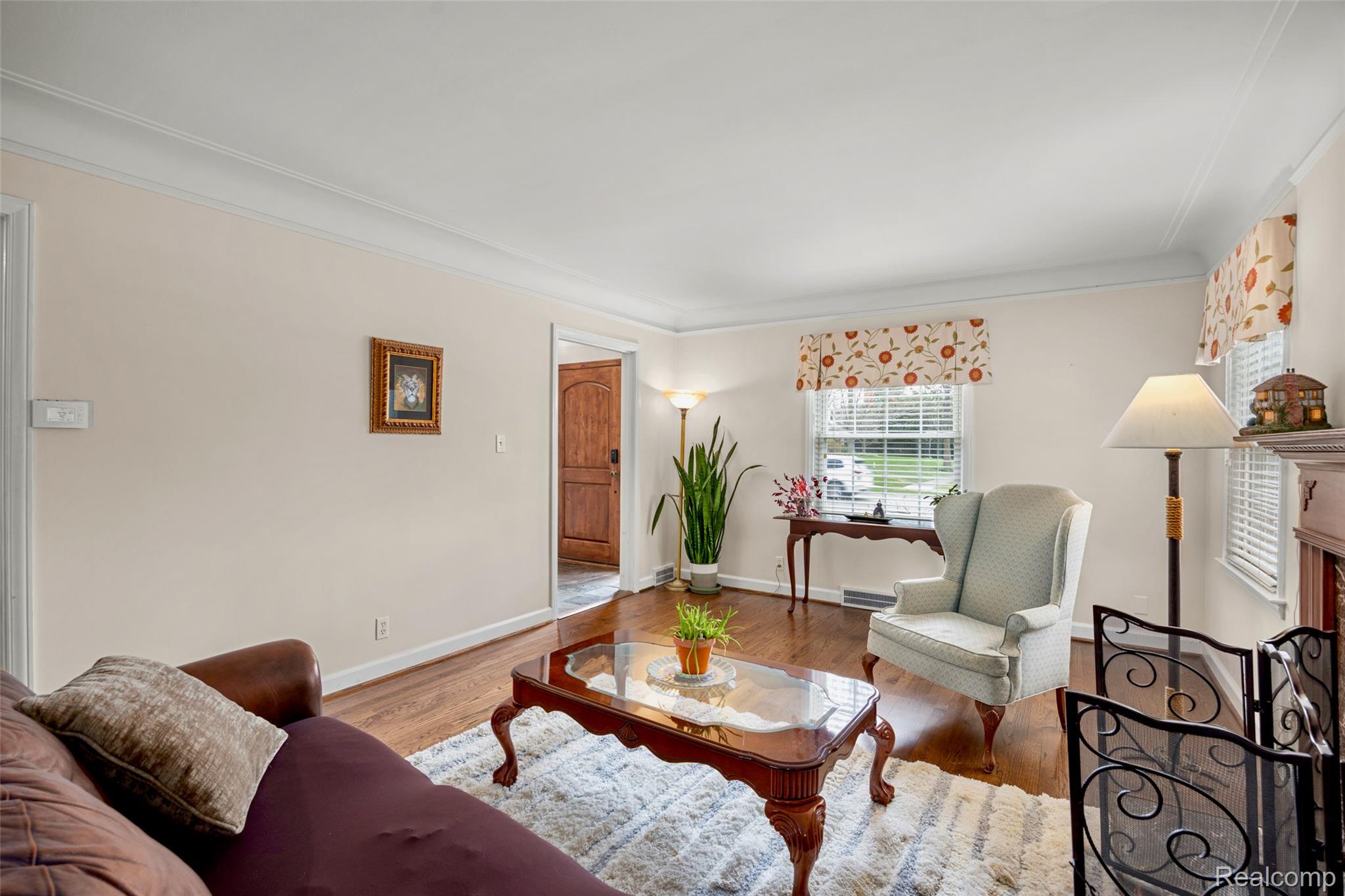 244 Kerby Road Grosse Pointe, MI 48236 - Photo 12 of 53 Living room with wood finished floors, ornamental molding, and a baseboard radiator