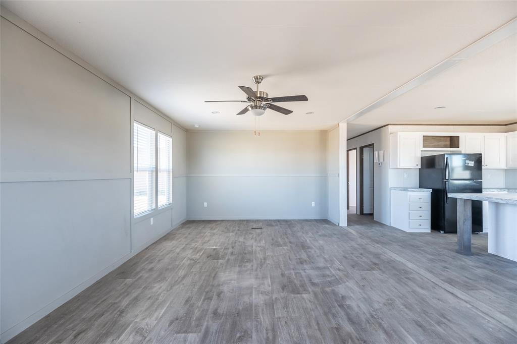 420 Haynes Street Merkel, TX 79536 - Photo 12 of 27 an empty room with windows and a ceiling fan