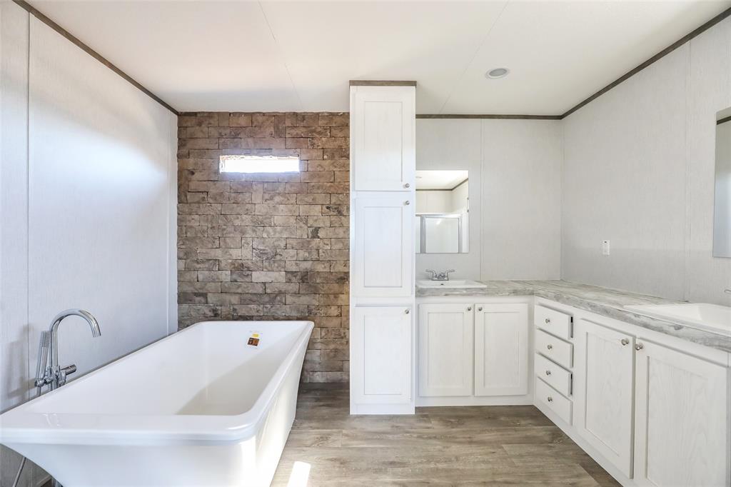 420 Haynes Street Merkel, TX 79536 - Photo 15 of 27 a bathroom with a granite countertop sink mirror and bathtub