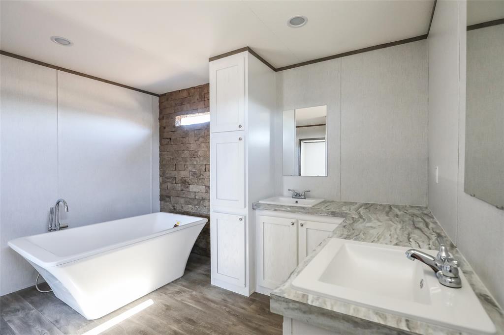 420 Haynes Street Merkel, TX 79536 - Photo 16 of 27 a bathroom with a bathtub and a sink