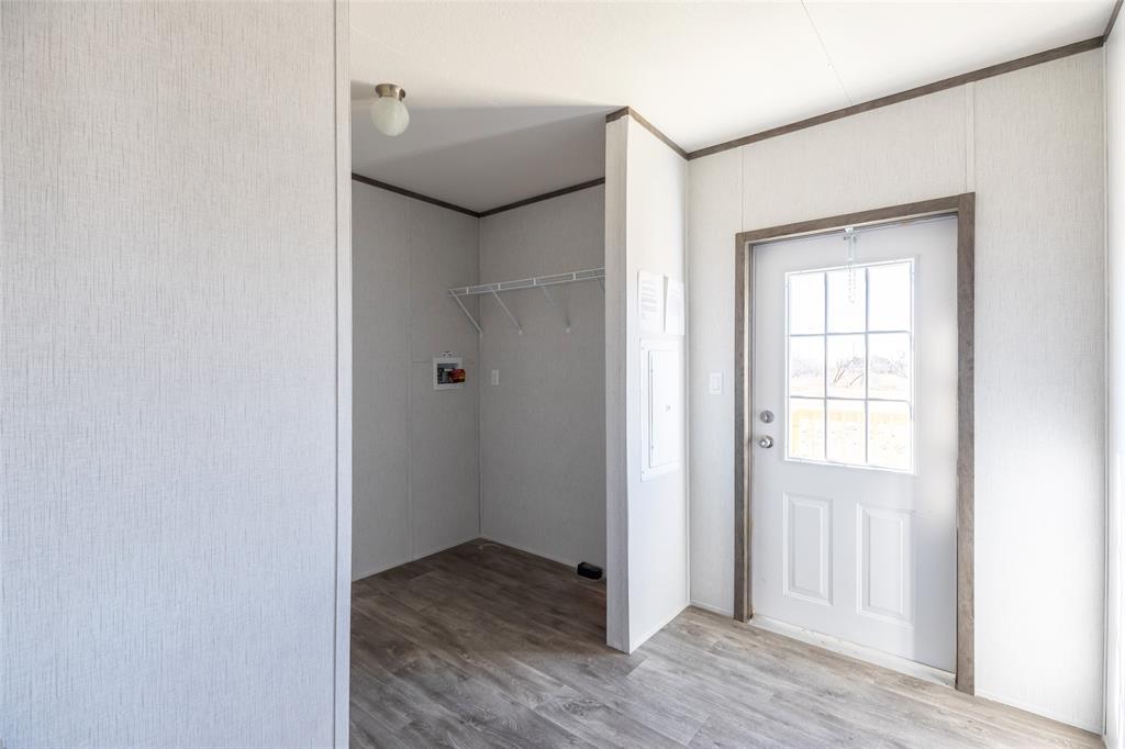 420 Haynes Street Merkel, TX 79536 - Photo 26 of 27 a view of an empty room with wooden floor and a window