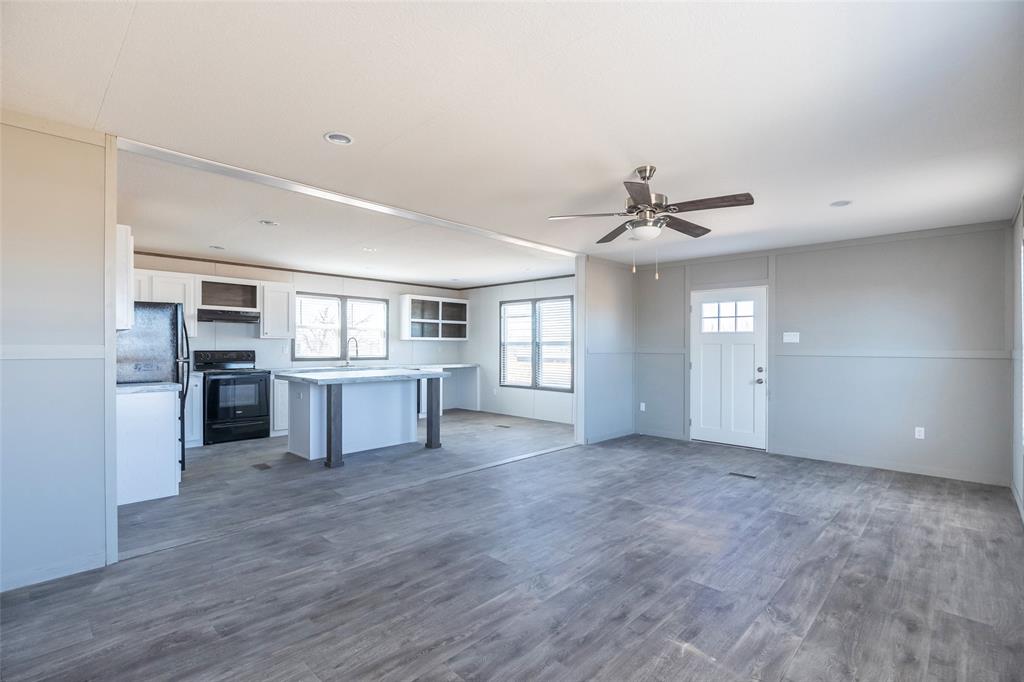 420 Haynes Street Merkel, TX 79536 - Photo 7 of 27 a view of a kitchen with a sink and a refrigerator