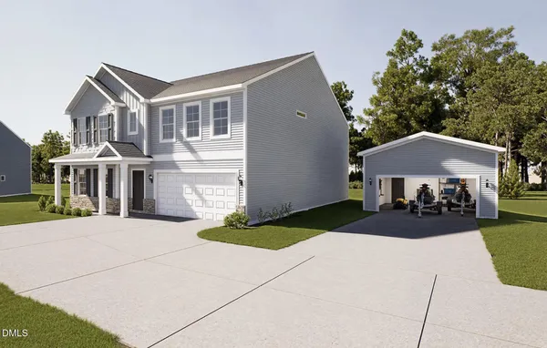 a front view of a house with yard and garage