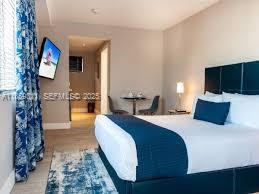 a spacious bedroom with bed and a couch