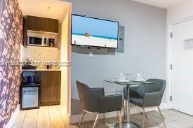 7310 Harding Avenue, Unit 1 Miami Beach, FL 33141 - Photo 2 of 6 a dining room with furniture and wooden floor