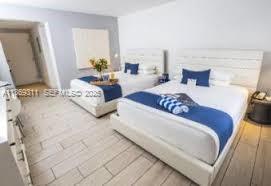 7310 Harding Avenue, Unit 1 Miami Beach, FL 33141 - Photo 3 of 6 a bedroom with double bed and a window