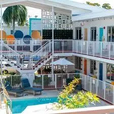 a view of a house with wooden deck and furniture