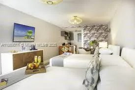 a bedroom with furniture and a chandelier