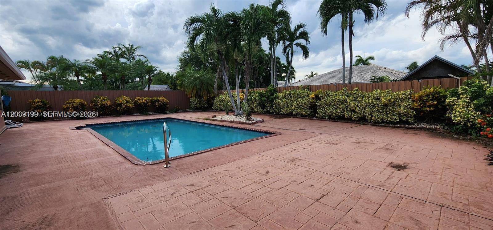 14817 Southwest 180th Street Miami, FL 33187 - Photo 14 of 15 a view of a swimming pool with a yard