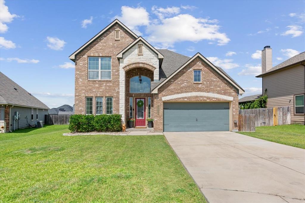 10856 Burnham Drive Waco, TX 76708 - Photo 1 of 1 a front view of a house with a yard and garage