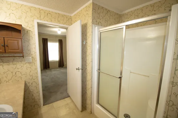 a bathroom with a glass shower door