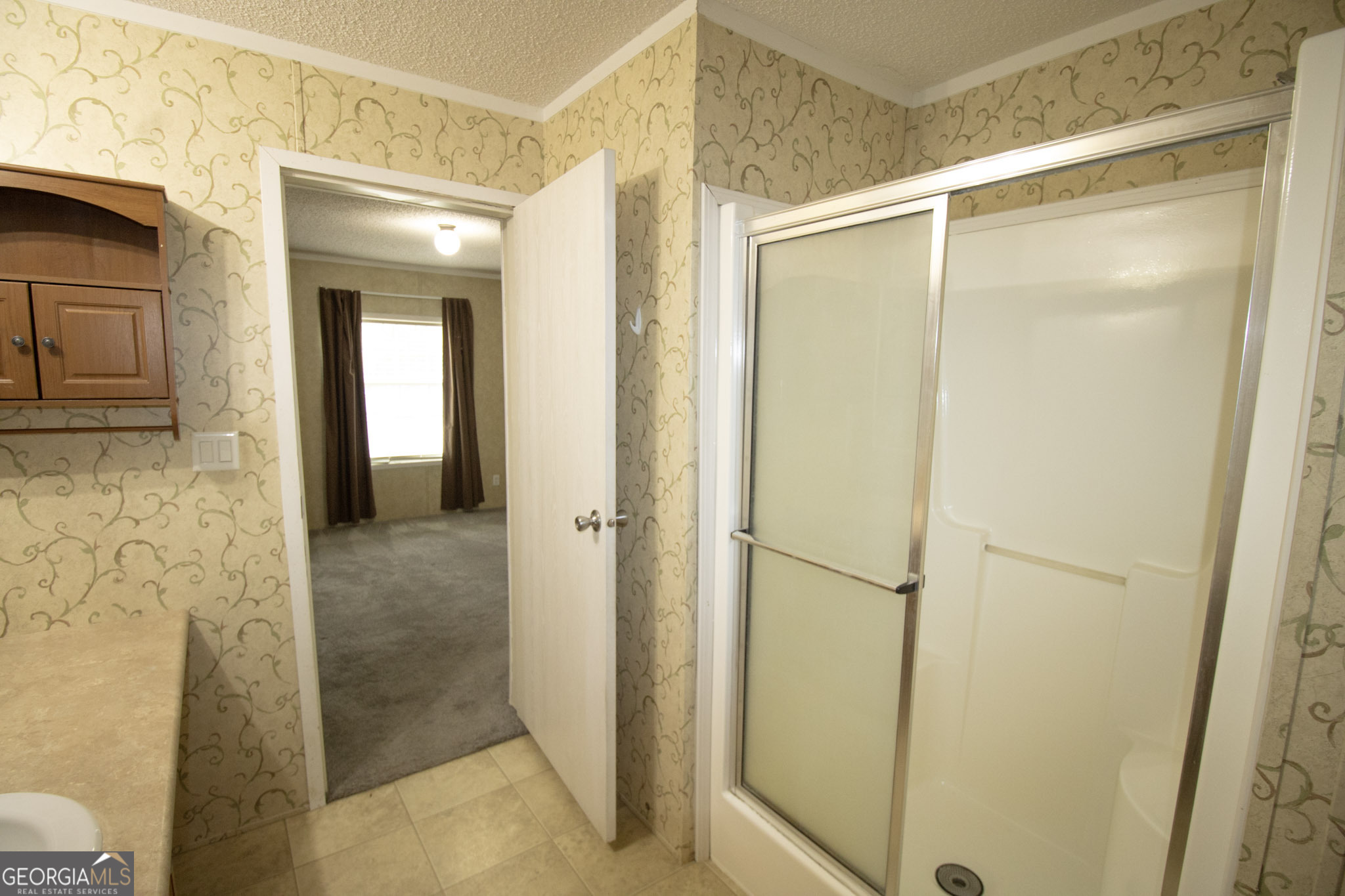 1776 Zettwell Road Statesboro, GA 30461 - Photo 11 of 20 a bathroom with a glass shower door