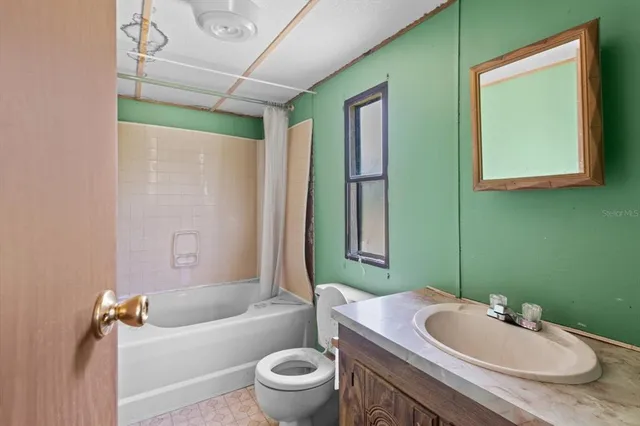 an aerial view of ocean with residential houses with outdoor space and trees