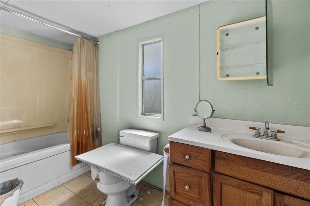 6177 County Road 625 Bushnell, FL 33513 - Photo 69 of 93 a bathroom with a sink and a mirror