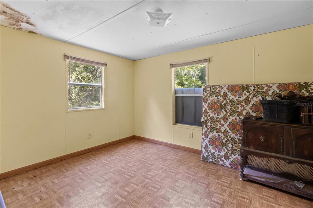 6177 County Road 625 Bushnell, FL 33513 - Photo 72 of 93 a view of a big room with windows and chandelier fan
