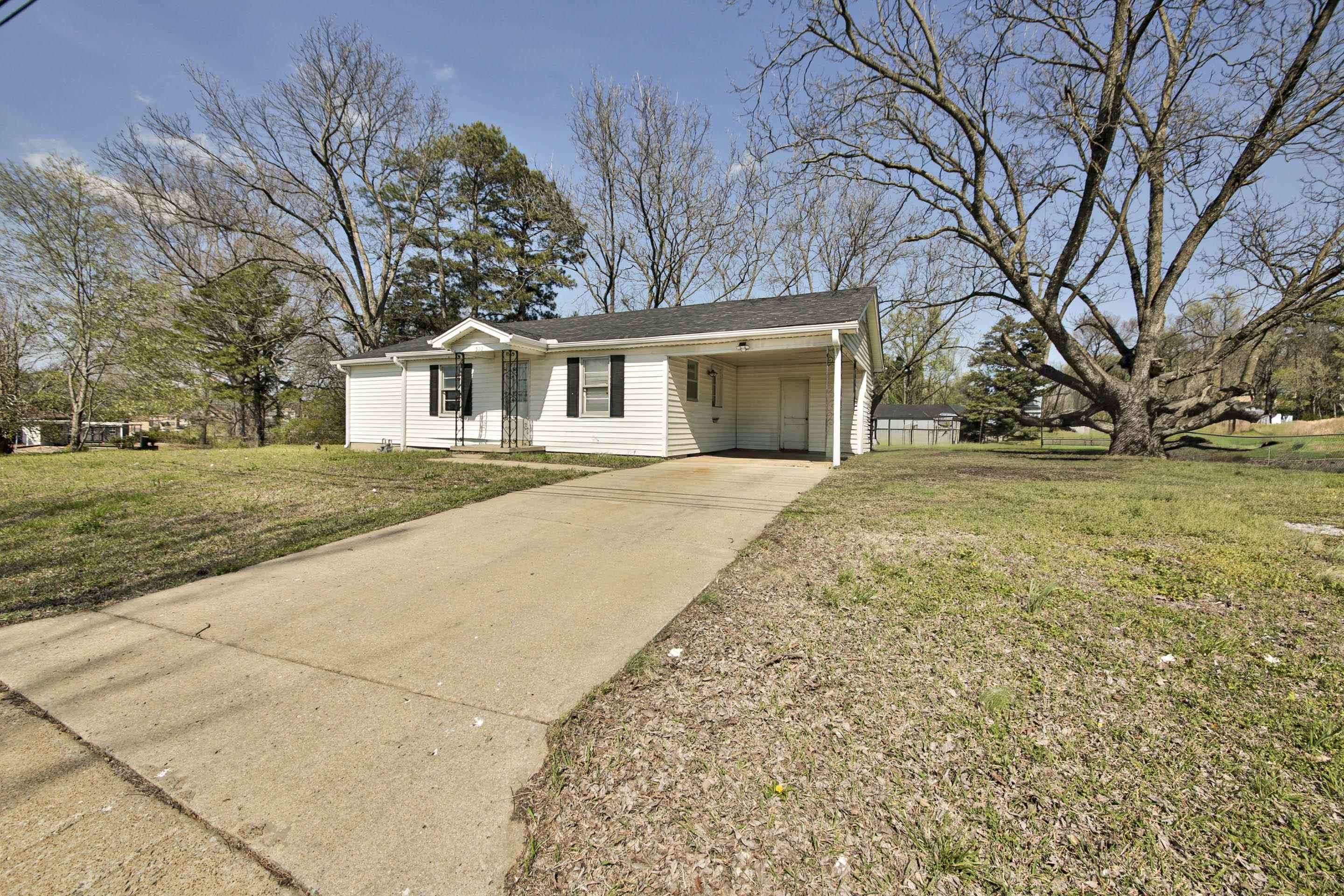 322 Highland Street Ripley, TN 38063 - Photo 2 of 12 a front view of a house with a yard and garage