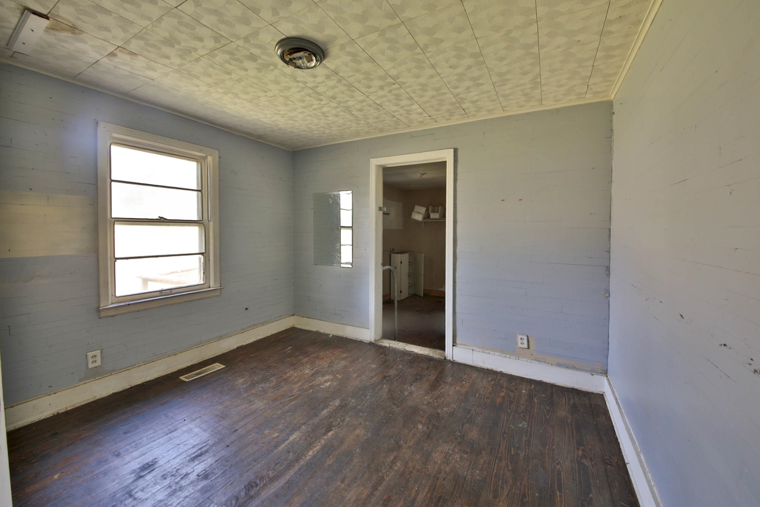 322 Highland Street Ripley, TN 38063 - Photo 9 of 12 an empty room with wooden floor and windows