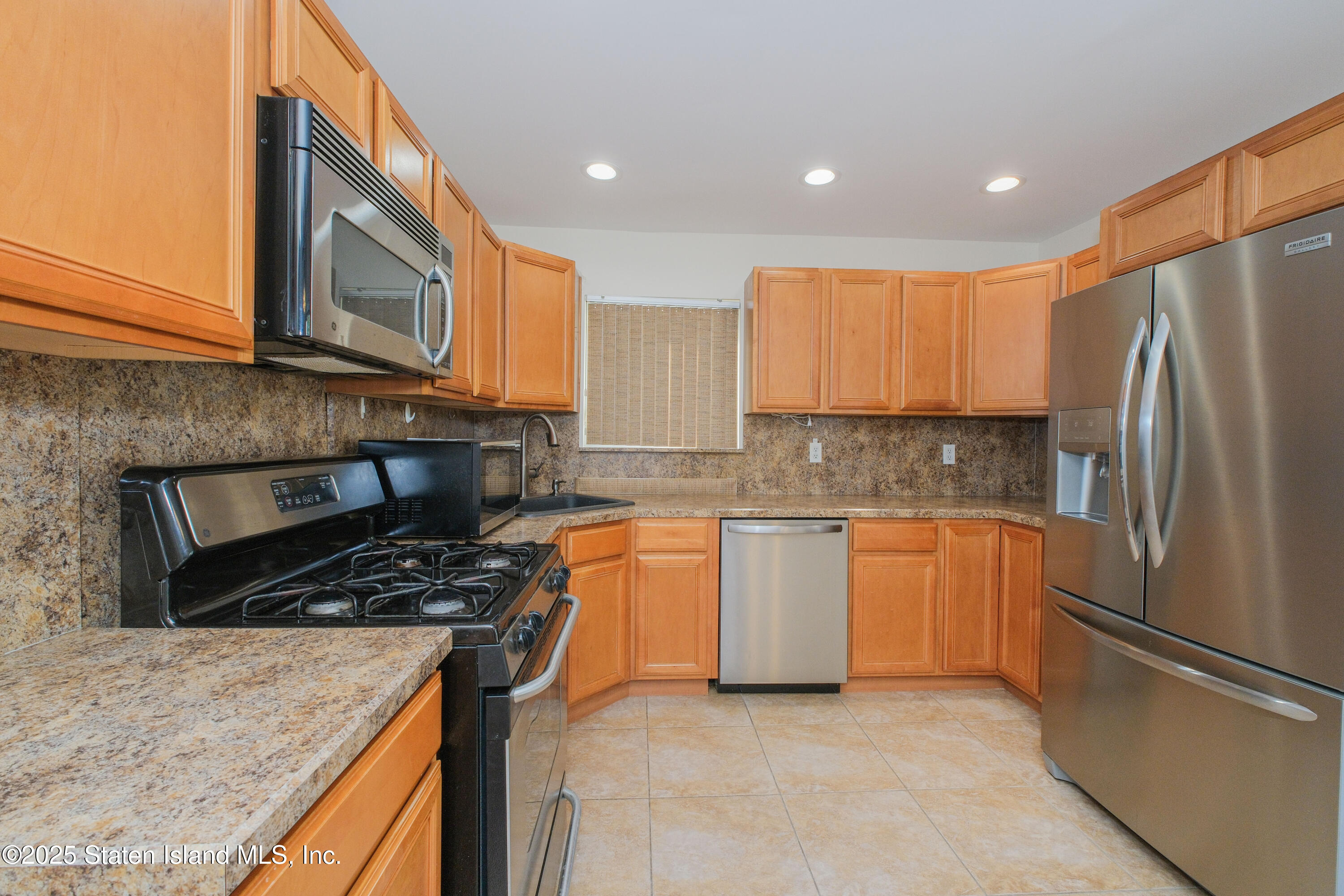 49 Endview Street Staten Island, NY 10312 - Photo 11 of 38 a kitchen with stainless steel appliances granite countertop a refrigerator stove top oven and sink
