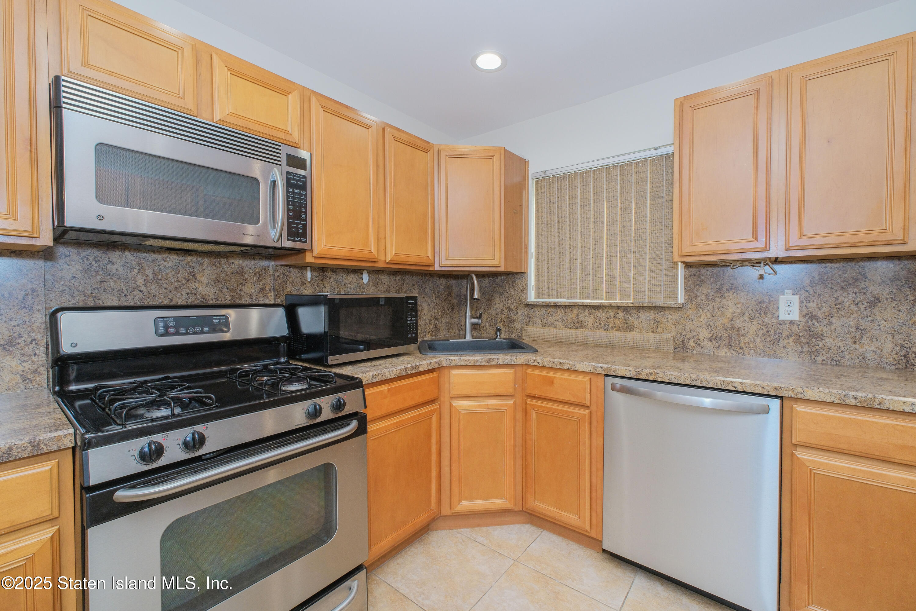 49 Endview Street Staten Island, NY 10312 - Photo 12 of 38 a kitchen with stainless steel appliances granite countertop a stove microwave and sink