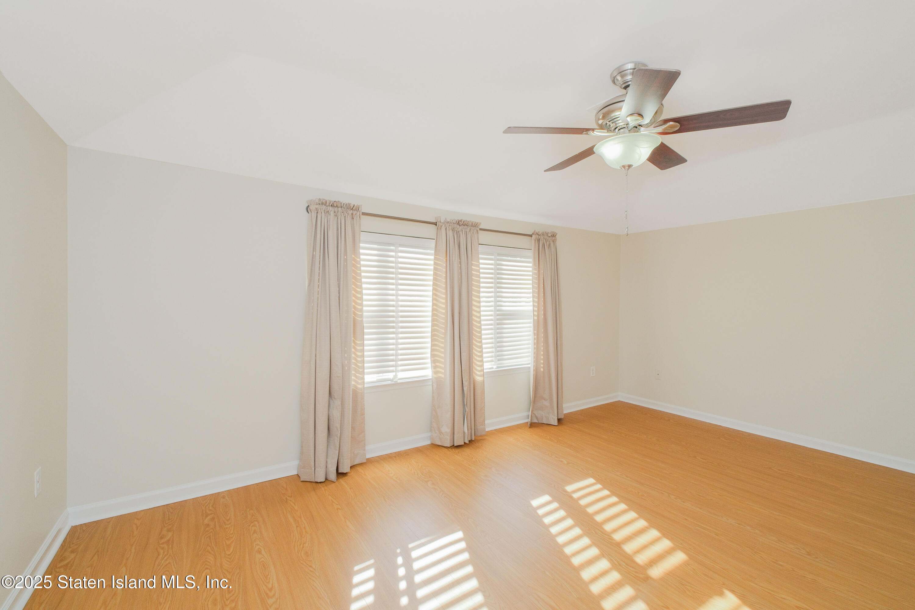 49 Endview Street Staten Island, NY 10312 - Photo 20 of 38 a bedroom with a bed and a chandelier