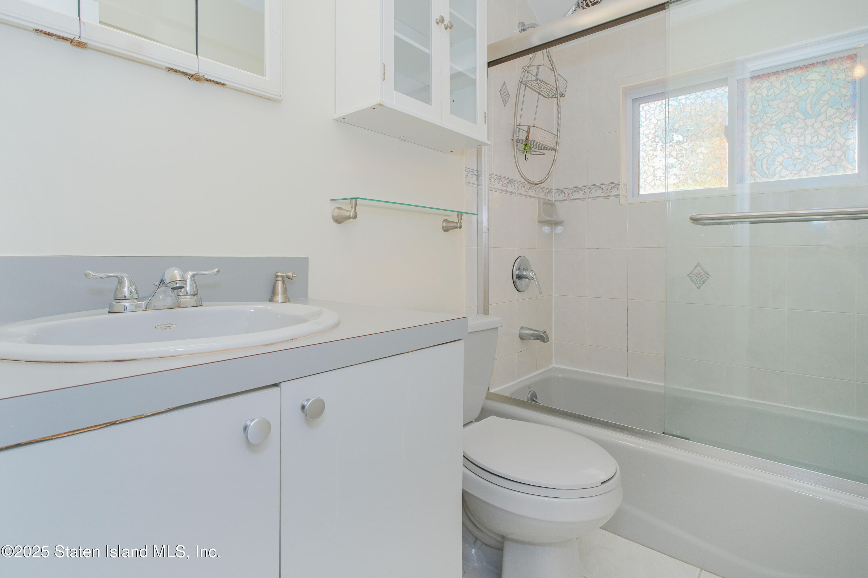 49 Endview Street Staten Island, NY 10312 - Photo 28 of 38 a bathroom with a sink a toilet and shower
