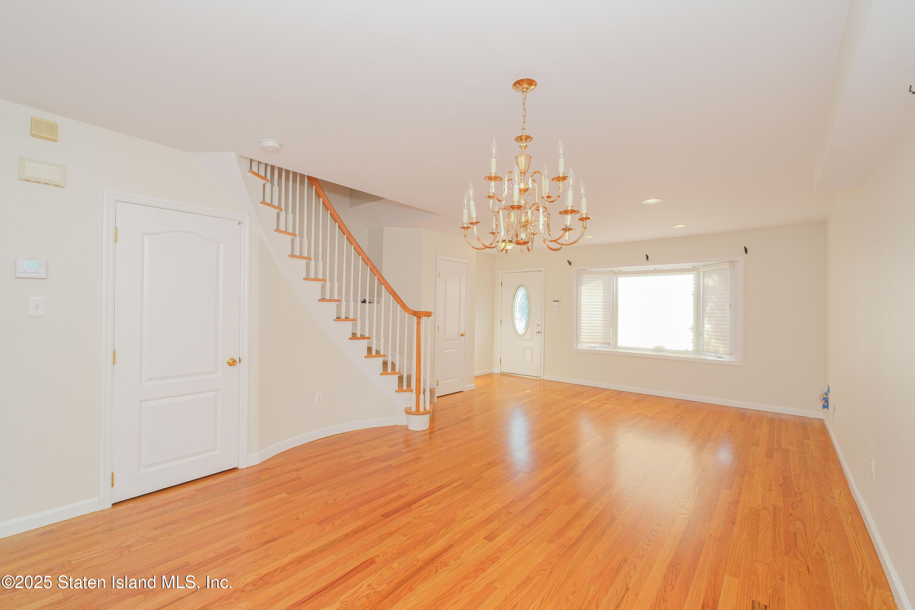 49 Endview Street Staten Island, NY 10312 - Photo 6 of 38 a view of a big room with wooden floor and chandelier