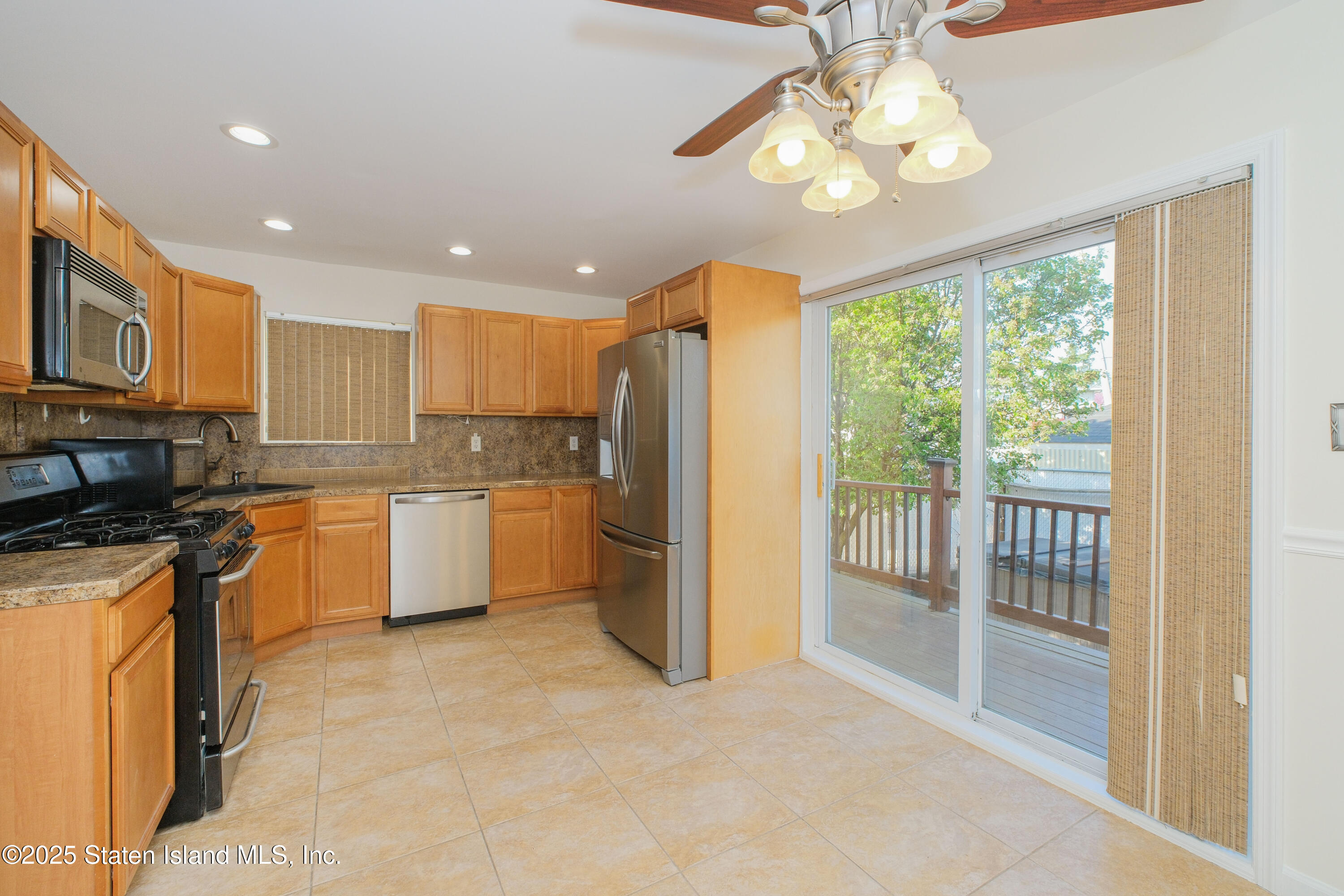 49 Endview Street Staten Island, NY 10312 - Photo 10 of 38 a large kitchen with a large window cabinets and stainless steel appliances