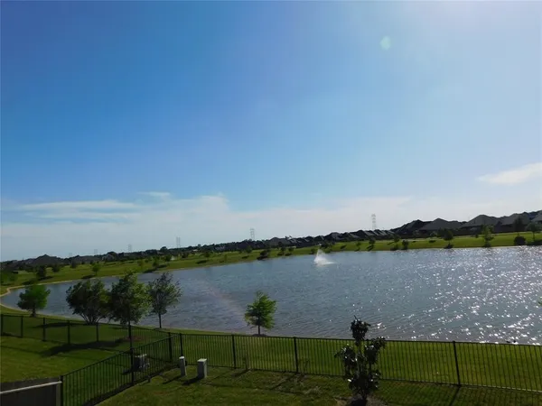 a view of a lake with houses in the back