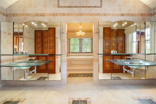 a view of a lobby with a sink and a large mirror