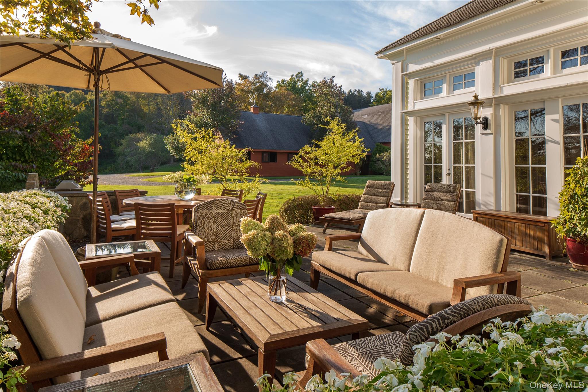 121-125 Butts Hollow Road Dover Plains, NY 12545 - Photo 16 of 30 a view of a patio with couches table and chairs and potted plants