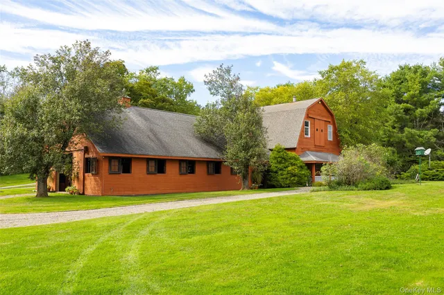 a front view of house with yard and green space